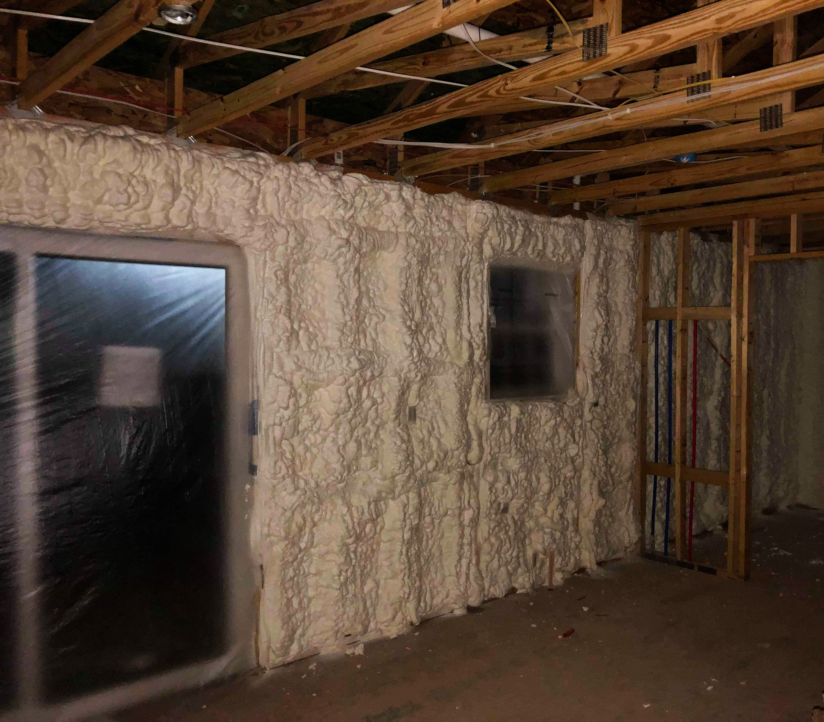 Insulated wall cavities with spray foam insulation