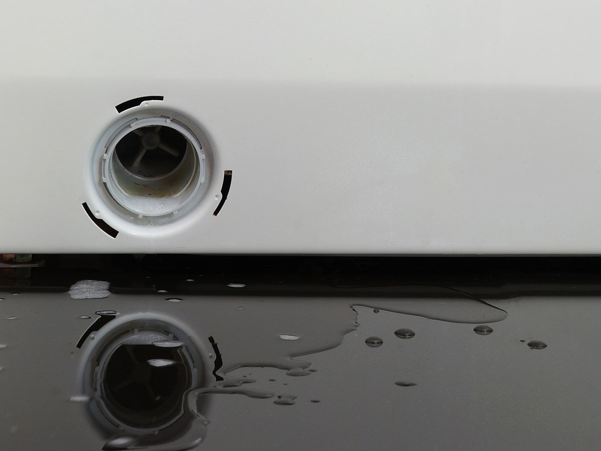 Clogged washing machine causing water damage and a bad odor.