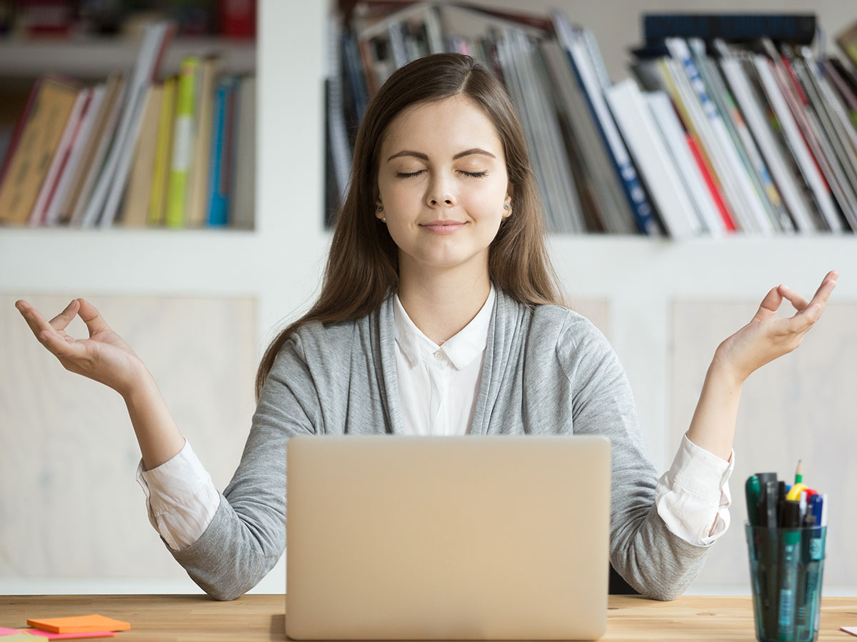 Young woman taking deep breath and meditating