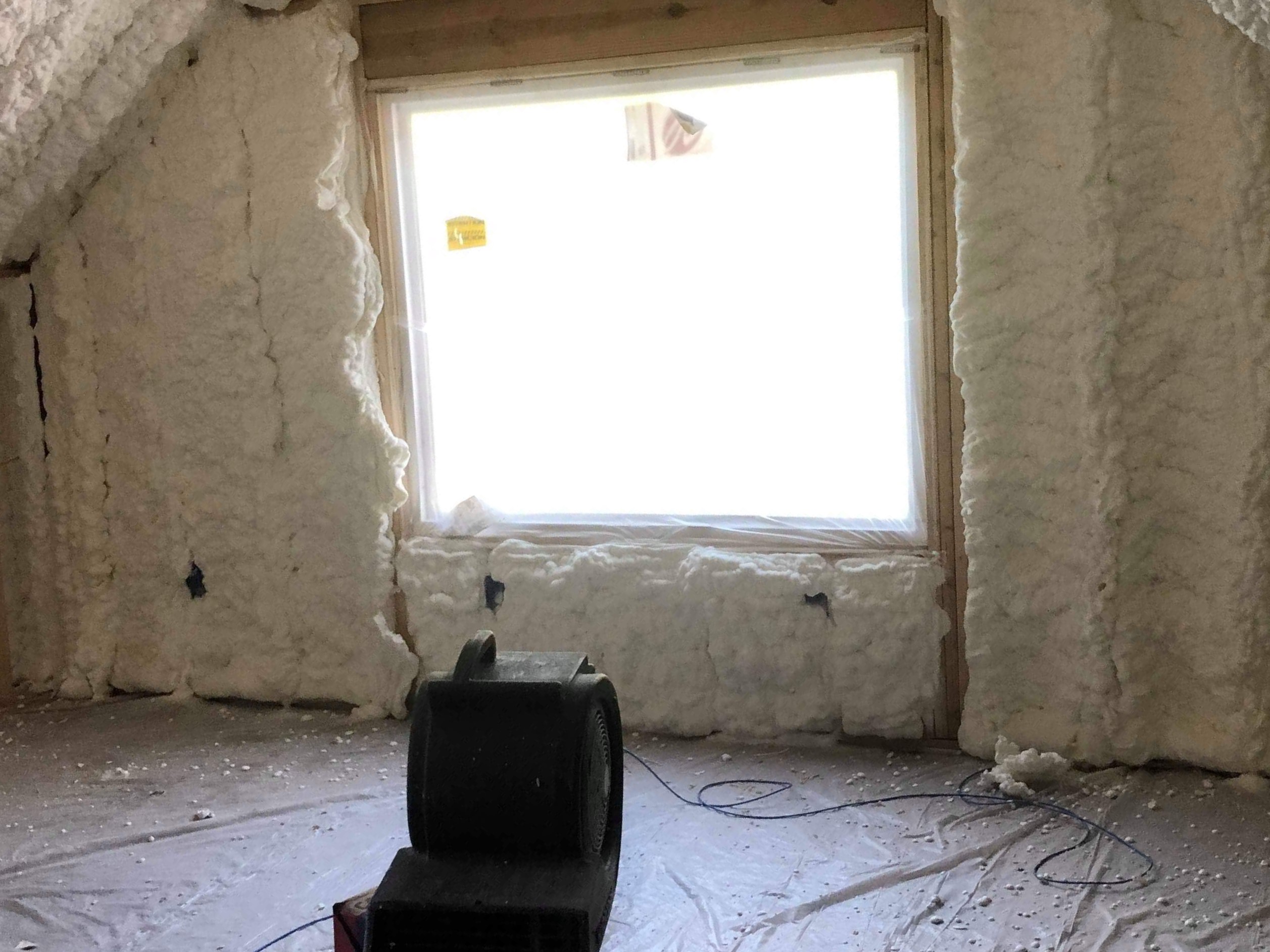 Windows and wall with spray foam insulation